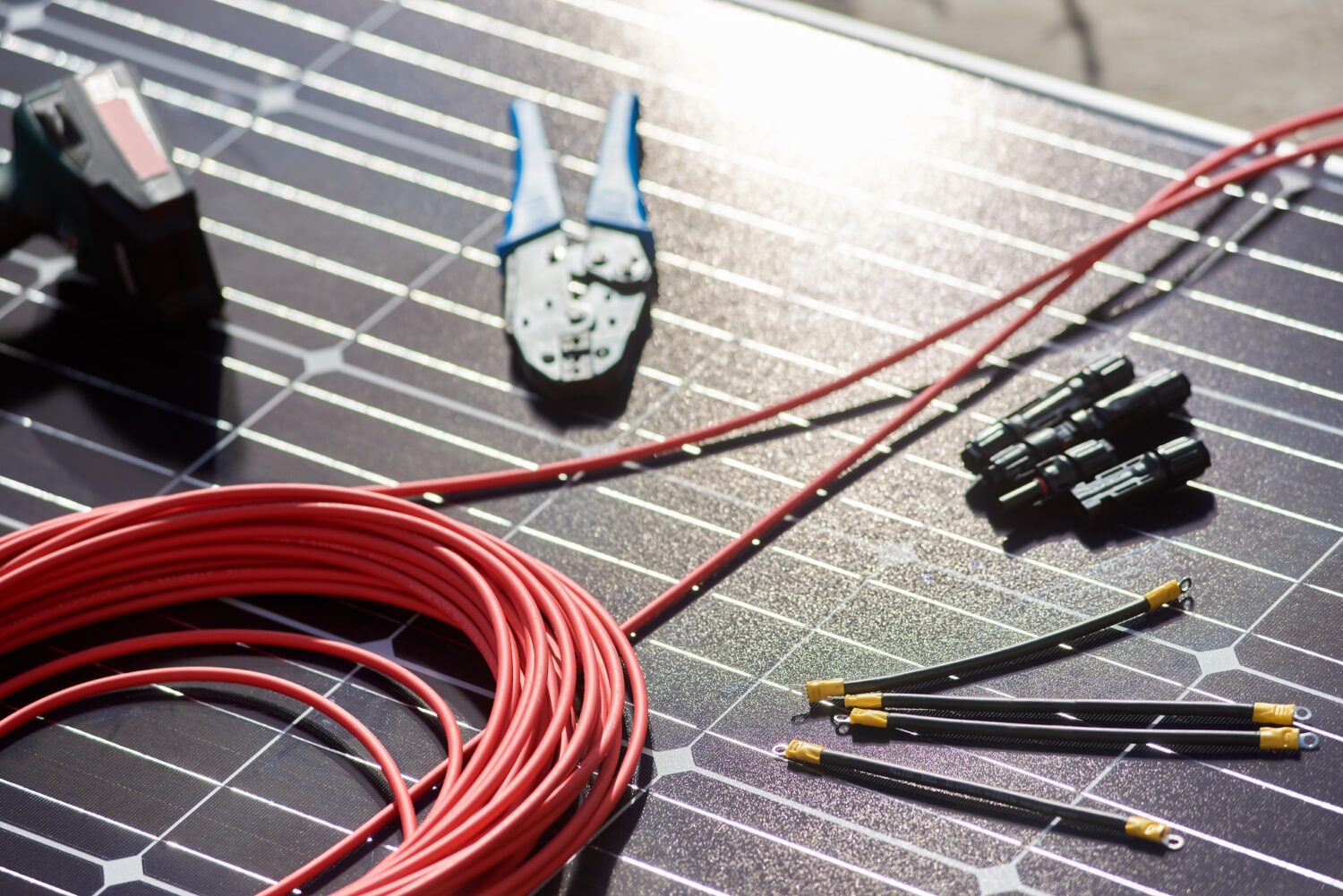 Close-up view of different details and instruments for mounting and connecting solar photovoltaic system.