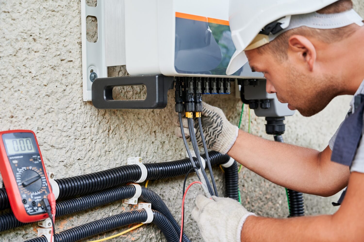Man electrician installing solar panel system.